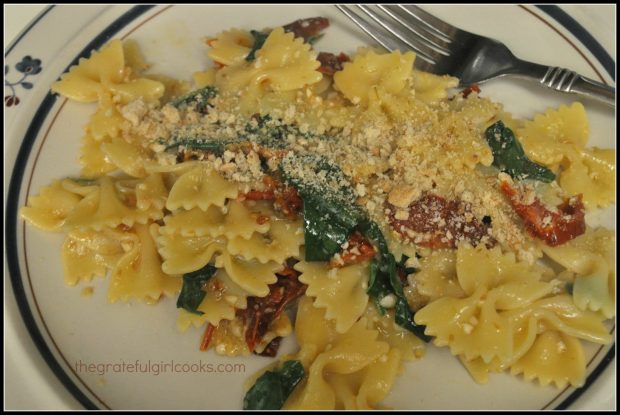 A serving of Farfalle Pasta with Arugula and Sun-Dried Tomatoes, topped with bread crumbs. 