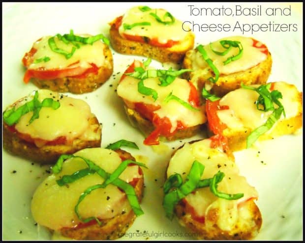 Tomato Basil Cheese Appetizers feature Roma tomatoes, fresh basil, and melted mozzarella cheese, resting on top of a garlic/oil infused french baguette slice