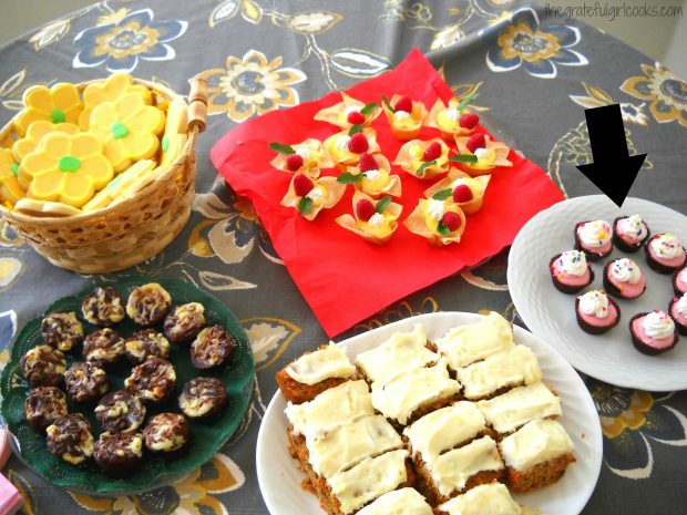 Dessert table including chocolate dream cups with raspberry mouse.