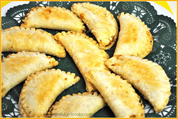 Ten apricot mini hand pies on green doily on plate, ready o eat!