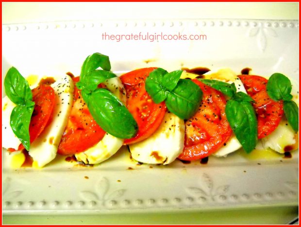 Caprese Salad , served on a white platter.