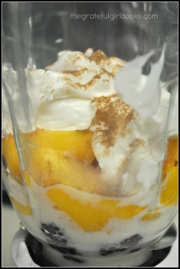 Almond milk and yogurt added to peaches and berries in blender