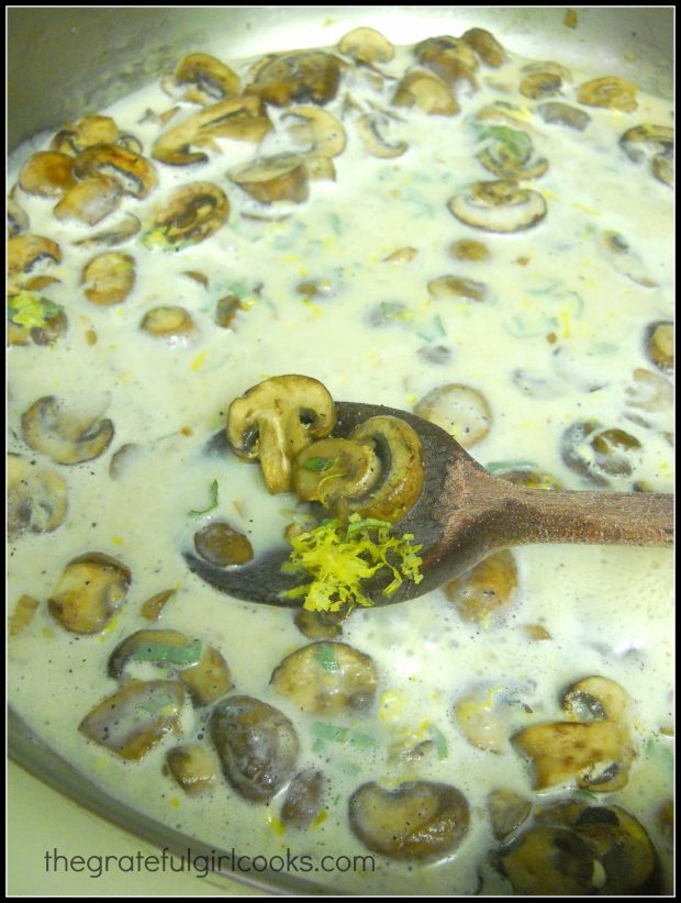 Sauce and lemon zest is added to the mushrooms in the skillet.