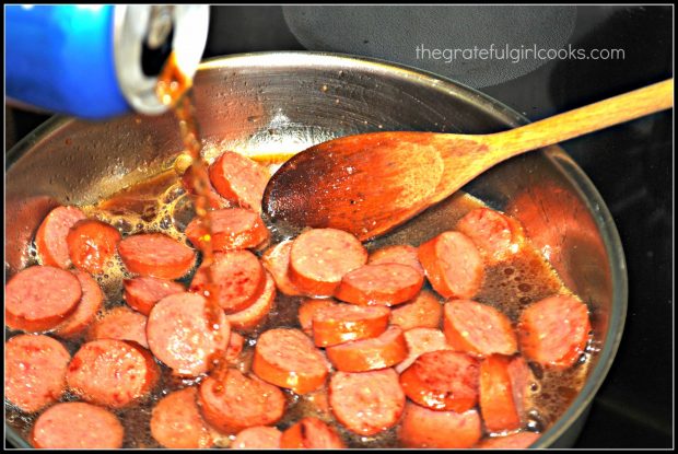 Cola is poured into skillet with polska kielbasa slices.