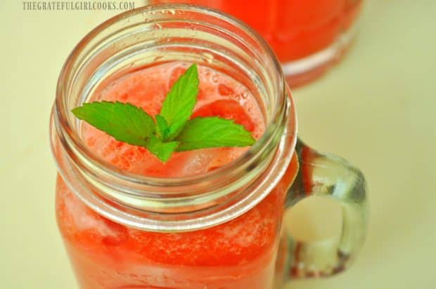 Watermelon agua fresca served over ice with fresh mint sprig