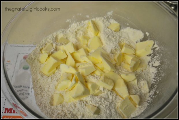 Chunks of cold butter are added to dry ingredients for cinnamon chip scones.