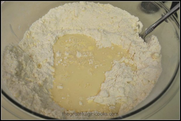 Buttermilk is added to cinnamon chip scones dough in bowl.