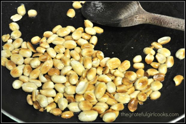 Raw peanuts to add to chicken are cooked in oil until golden brown.