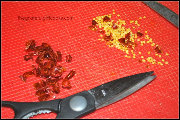 Seeds are separated from red chili peppers before cooking dish.