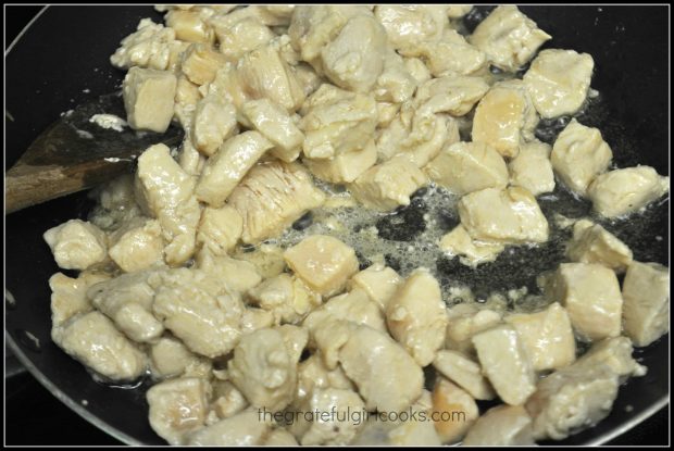 Chicken breast cubes are cooked in hot oil until golden brown.