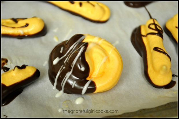 The meringues are dipped in chocolate and drizzled with more chocolate.
