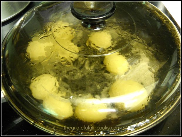 Rissole potatoes are steamed in covered pot, with butter.