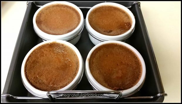 Four ramekins of brulee, out of the oven after baking.