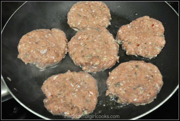 6 breakfast sausage patties cooking in skillet