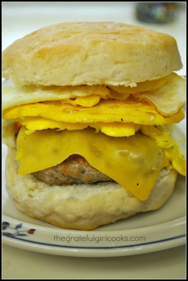 Breakfast sausage patty on biscuit with egg and cheese