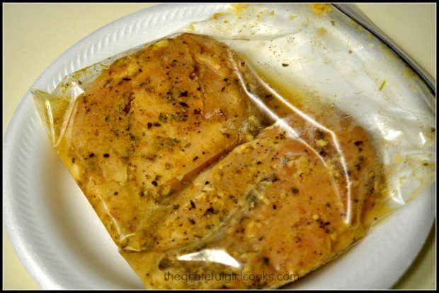 Chicken breasts are marinated before cooking.