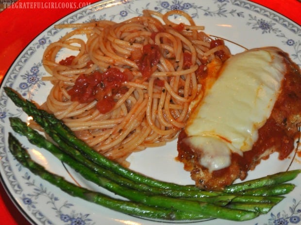 Pasta and asparagus are served alongside Mom's chicken parmigiana.