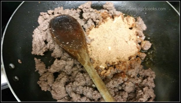 The taco seasoning mix is added to a pound of browned hamburger meat.
