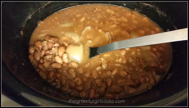 Refried beans are ready to mash after cooking all day in the crock pot