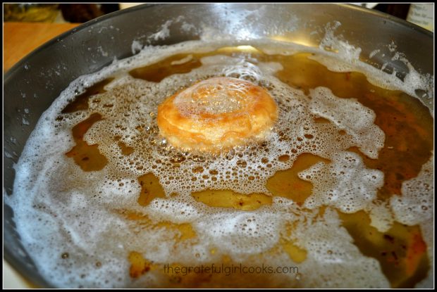 The pumpkin buttermilk doughnuts are fried in oil to cook.