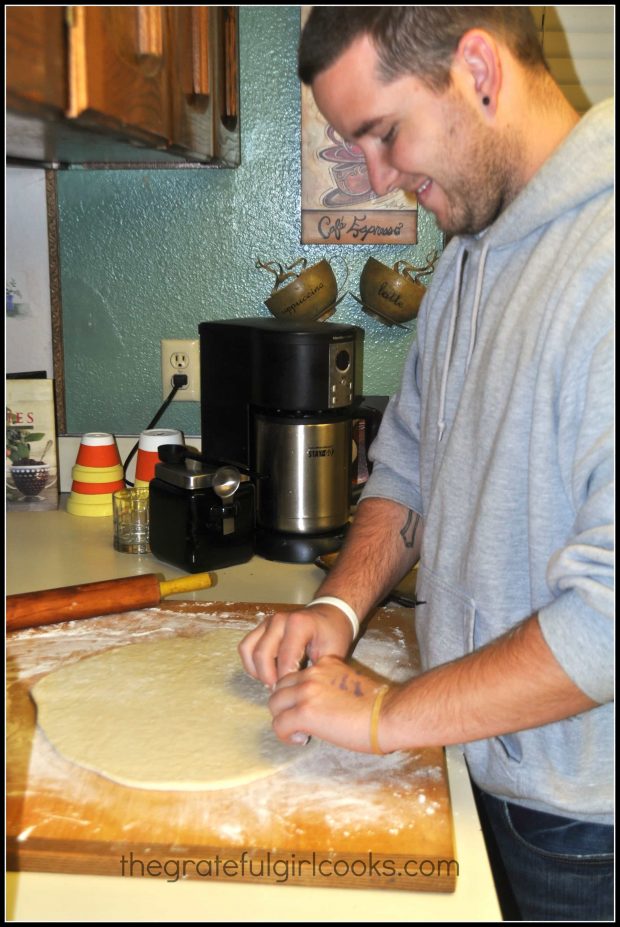 Our son rolling the dough to make a loaf of miracle bread.