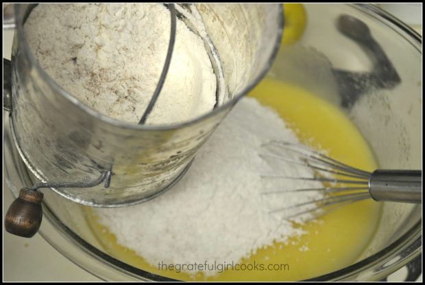 Dry ingredients are sifted into the cake batter.