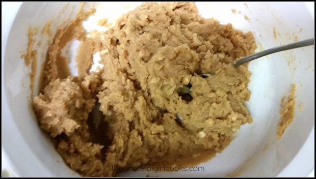Peanut butter cookie dough is mixed in white bowl