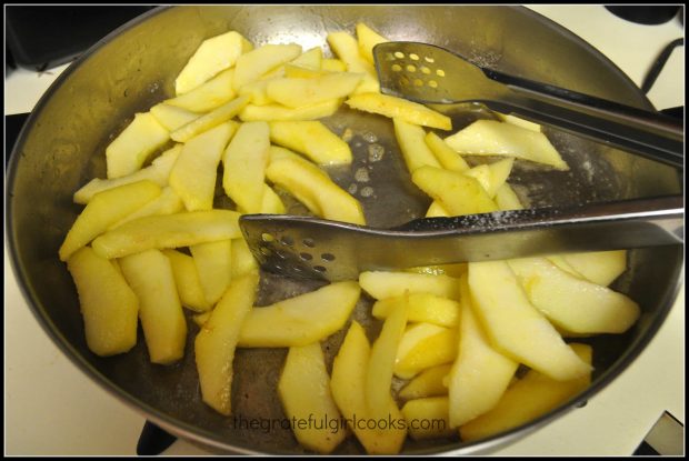 Cooking the apples in melted butter in a skillet.