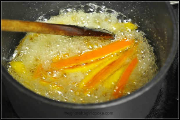 Citrus peels are cooked in a boiling sugar and water mixture for 15 minutes.