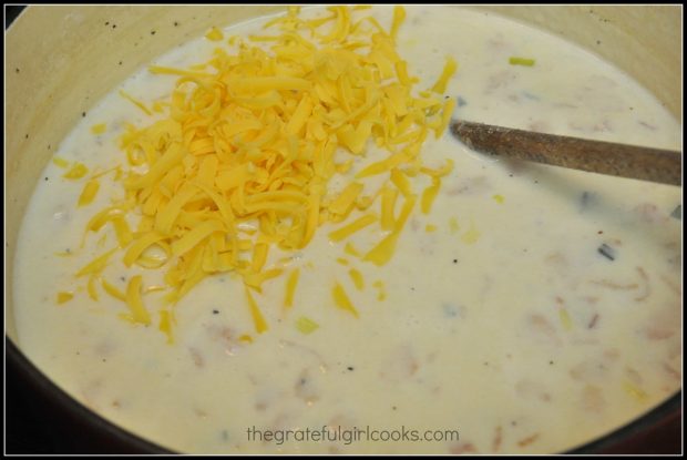 Milk, whipping cream and cheddar cheese are added to potato soup.