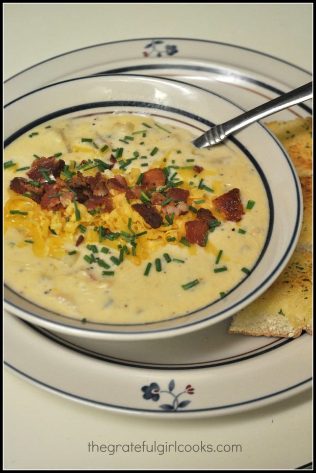 Fully Loaded Potato Soup is garnished with crisp bacon, cheddar and chives.