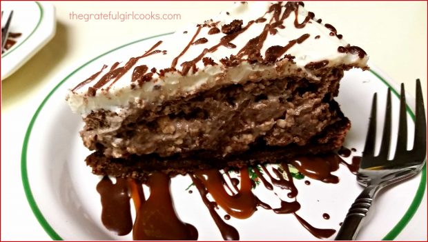 A slice of chocolate fudge truffle cheesecake on a plate.