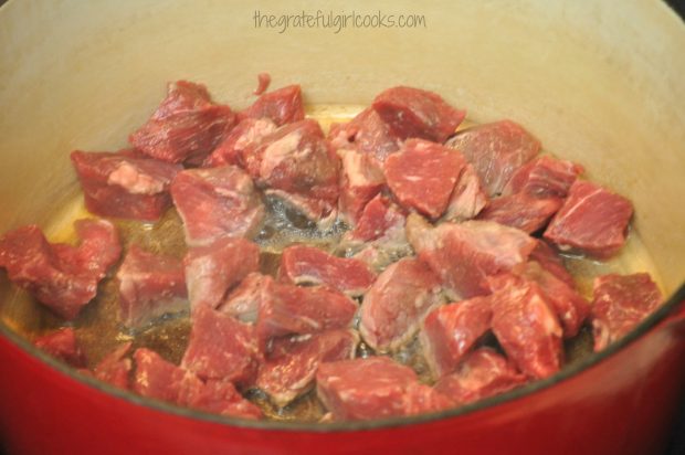 Beef stew meat is browned in ovenproof pan.
