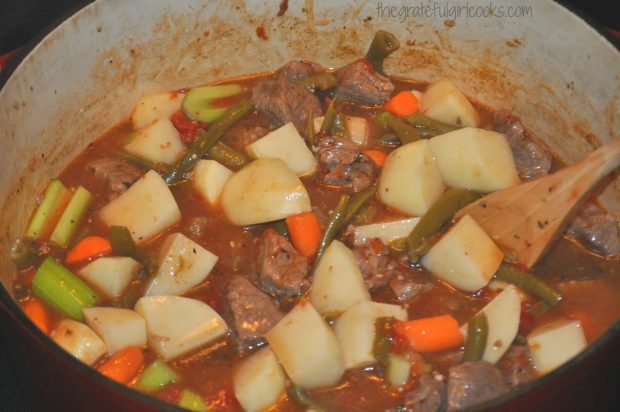 Classic beef stew goes back into oven after veggies are added.