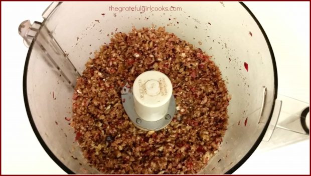 Cranberries, brown sugar and pecans are chopped in a food processor, for cranberry-orange pinwheel cookies.