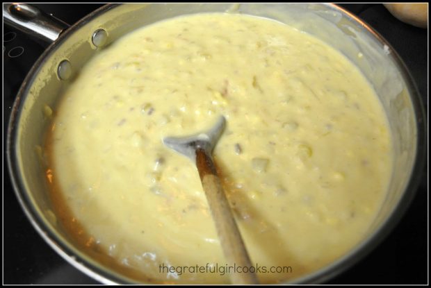 Chicken enchilada casserole sauce cooks until thick and creamy.