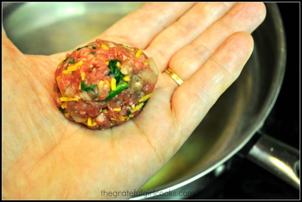 A meatball being held in the palm of my hand.