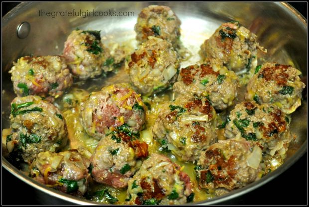 Browned meatballs in skillet.