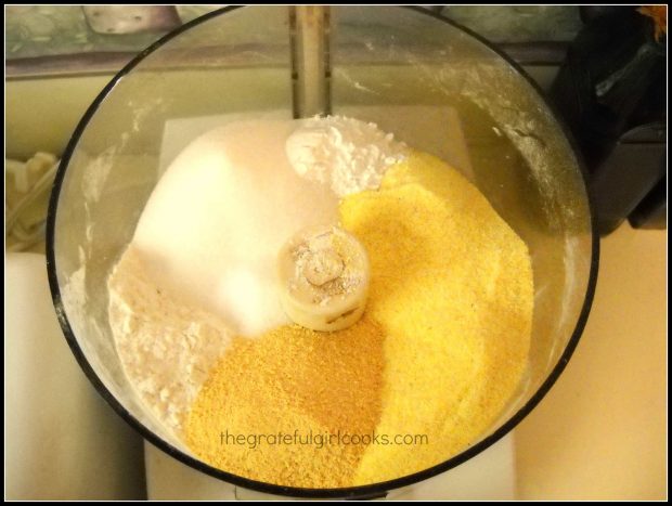 Mixing dry ingredients for cornbread in food processor.