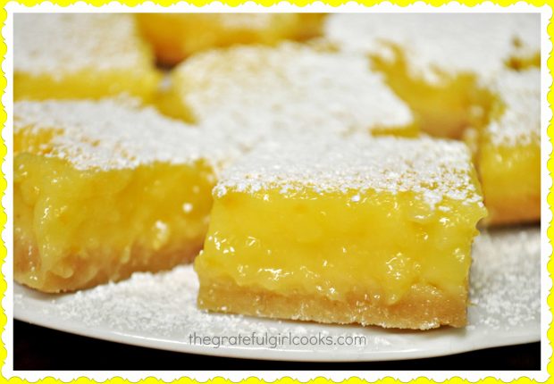 Close up photo of lemon bars on a white plate.