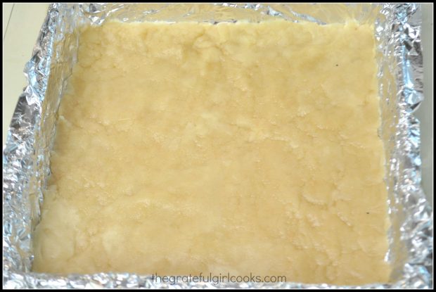 Dough is pressed into bottom of dish to form base for lemon bars