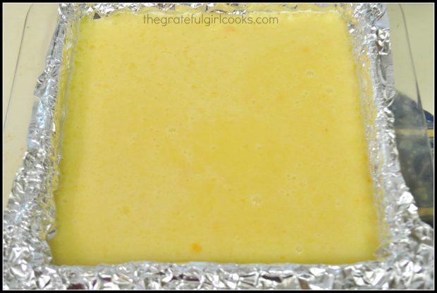 Lemon filling is poured onto crust in baking dish and baked