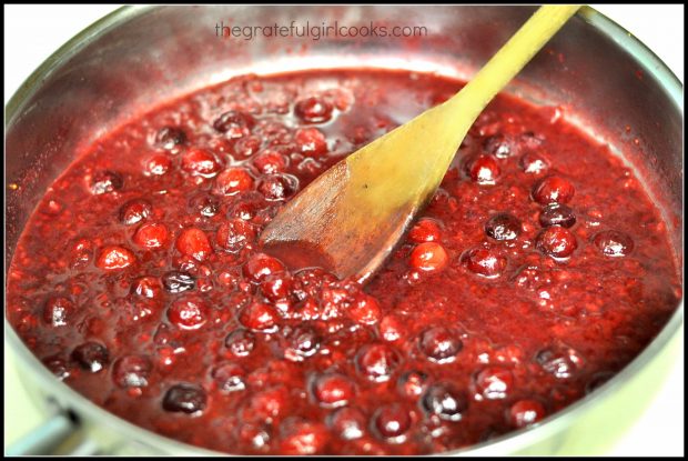 Cranberry-raspberry sauce for pork tenderloin cooking in skillet.