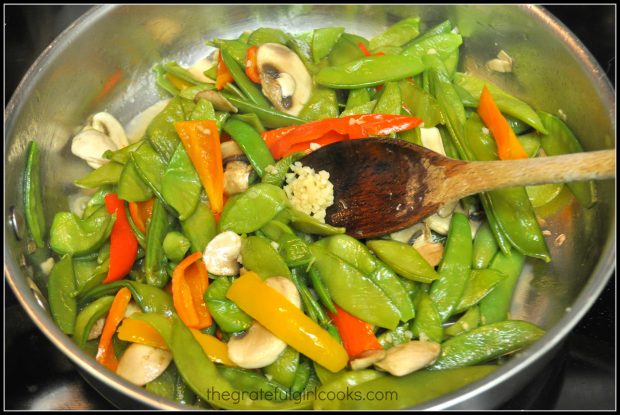 Garlic is added to sugar snap pea stir fry for added flavor.