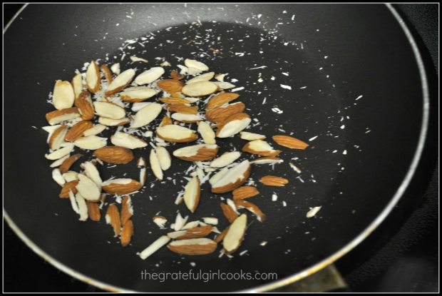 Almonds are lightly toasted in skillet, to add as topping for sugar snap pea stir fry.
