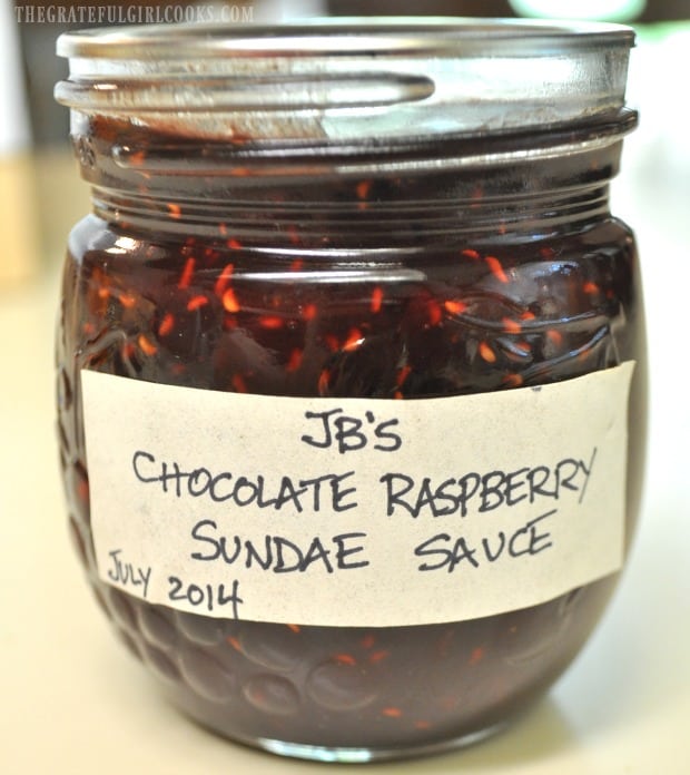 Jar of chocolate raspberry sundae sauce ready to store in pantry.