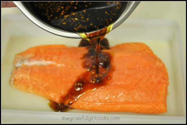 Teriyaki marinade is poured over the salmon to cover.