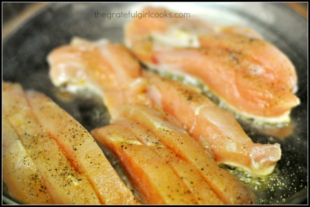 Seasoned chicken strips are pan-seared in skillet.