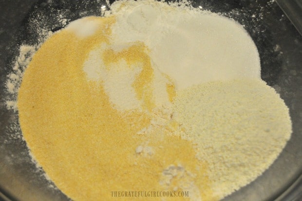 Ingredients for cornbread in bowl for hand mixing.