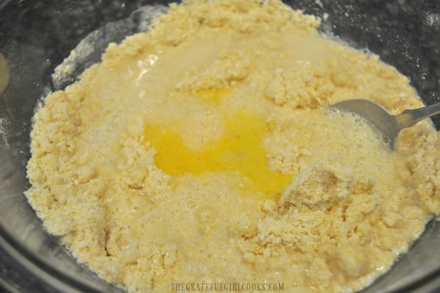Eggs are added to dry ingredients and combined to make cornbread batter.